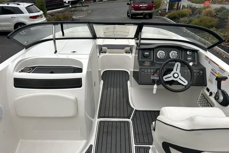 Slide: The Image of 2022 Bayliner VR6 Bowrider OB interior with steering wheel and dashboard controls. - 2