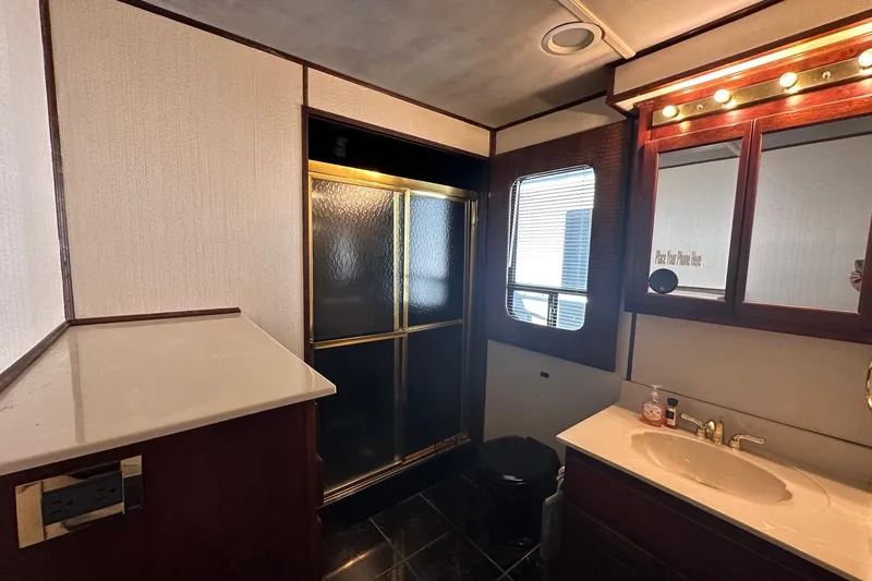 Slide: The Image of Bathroom interior of 1998 Stardust Cruisers 16x86 houseboat with shower and vanity. - 10
