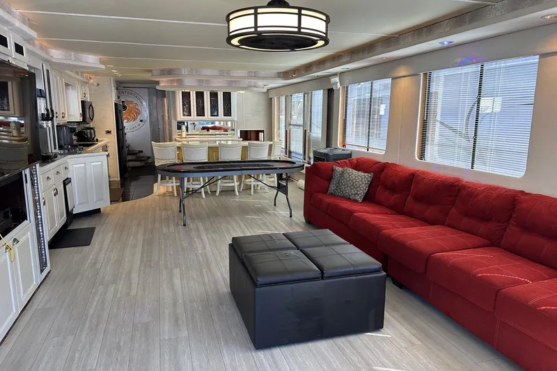 Slide: The Image of Luxurious 1998 Stardust Cruisers 16x86 interior with red sofa, dining area, and modern kitchen. - 2