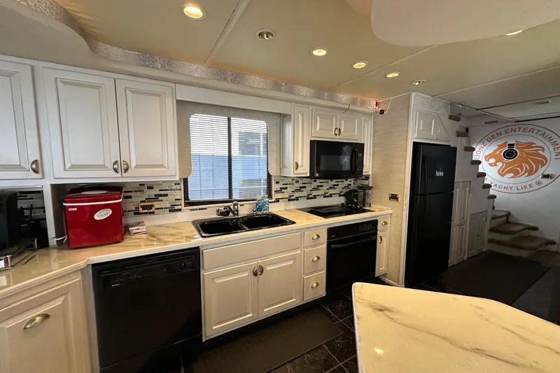 Slide: The Image of Kitchen interior of 1998 Stardust Cruisers 16x86 houseboat with modern appliances and stylish decor. - 4