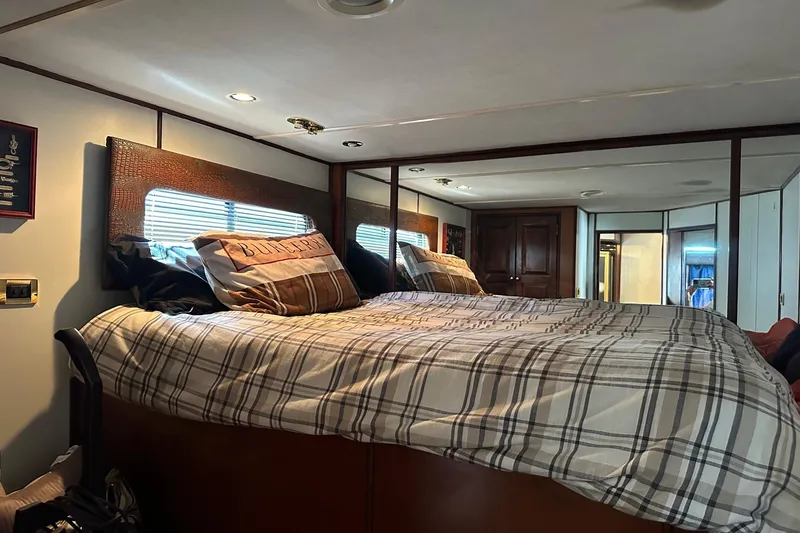 Slide: The Image of Cozy bedroom interior of 1998 Stardust Cruisers 16x86 houseboat with plaid bedding. - 7