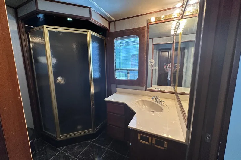 Slide: The Image of Luxurious bathroom in 1998 Stardust Cruisers 16x86 houseboat with shower and vanity. - 8