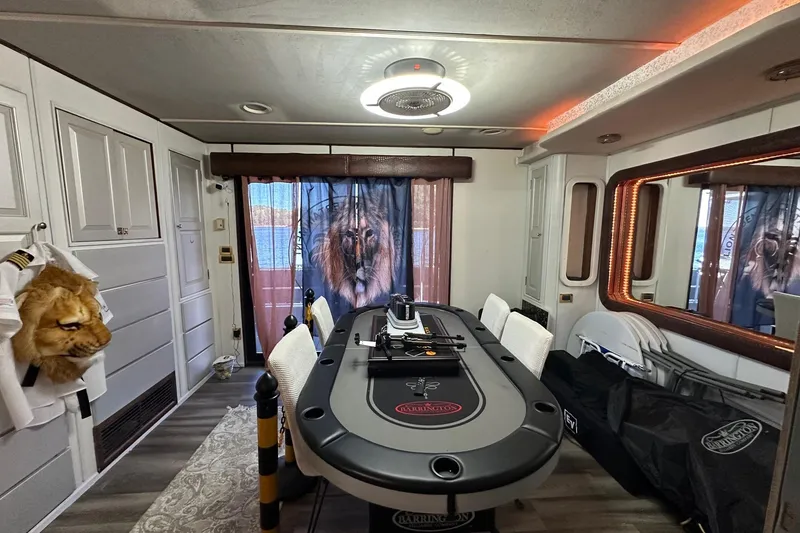 Slide: The Image of Luxurious 1998 Stardust Cruisers 16x86 interior with poker table and lion-themed decor. - 9