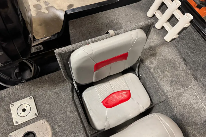 Slide: The Image of 2016 Tracker Pro Guide V-175 Combo boat seat with red accents and rod holders. - 15