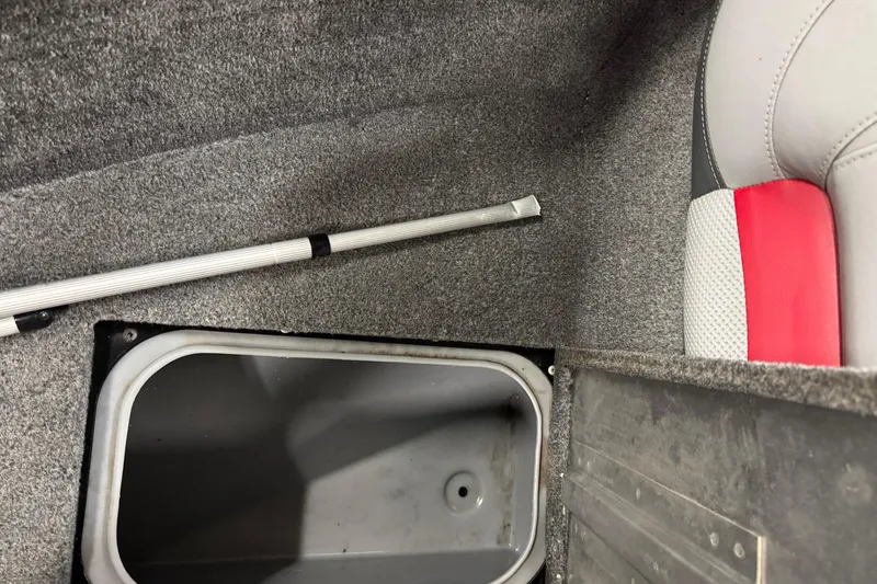 Slide: The Image of Interior of 2016 Tracker Pro Guide V-175 Combo boat showing storage compartment and seat. - 21