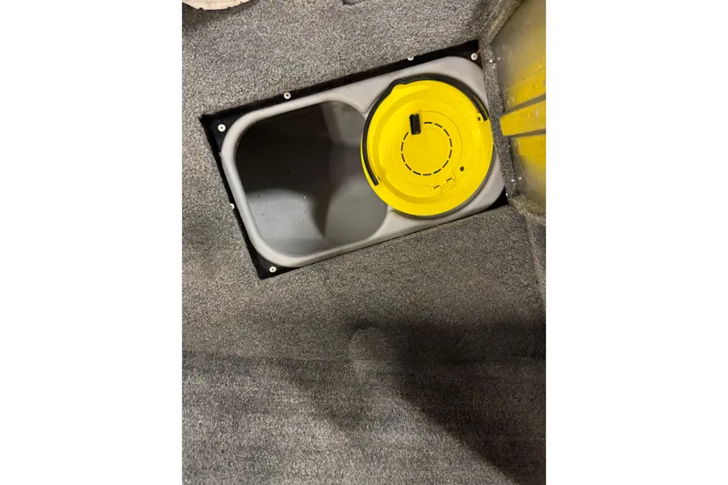 Slide: The Image of 2016 Tracker Pro Guide V-175 Combo boat storage compartment with yellow lid. - 22