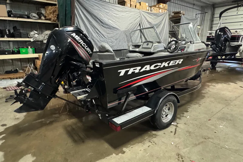 Slide: The Image of 2016 Tracker Pro Guide V-175 Combo boat with Mercury engine in a garage setting. - 3
