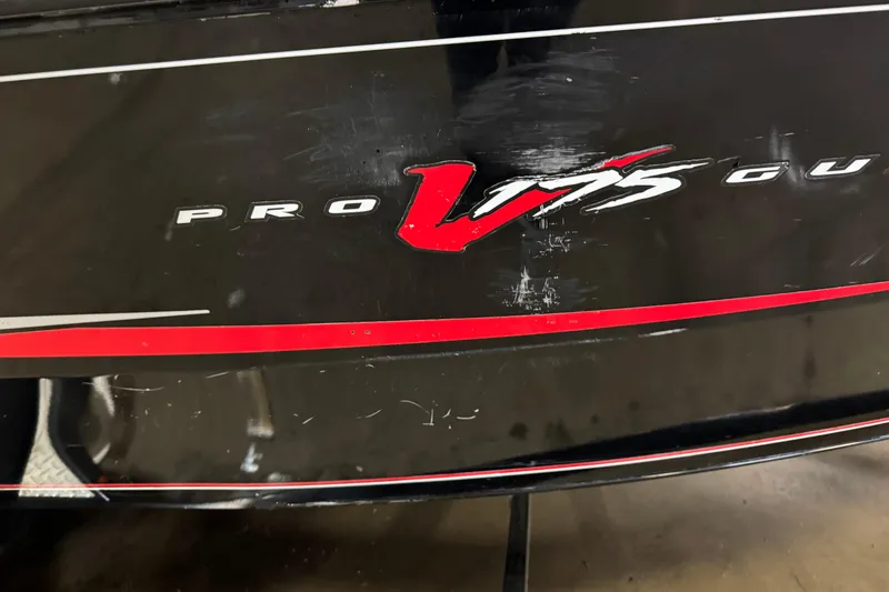 Slide: The Image of 2016 Tracker Pro Guide V-175 Combo boat with red and white graphics on black surface. - 6