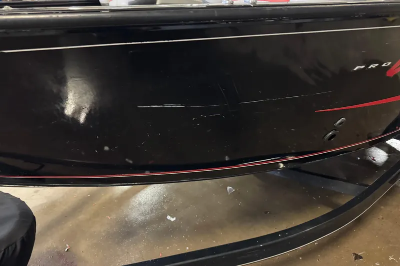 Slide: The Image of 2016 Tracker Pro Guide V-175 Combo boat with visible scratches on black hull. - 8