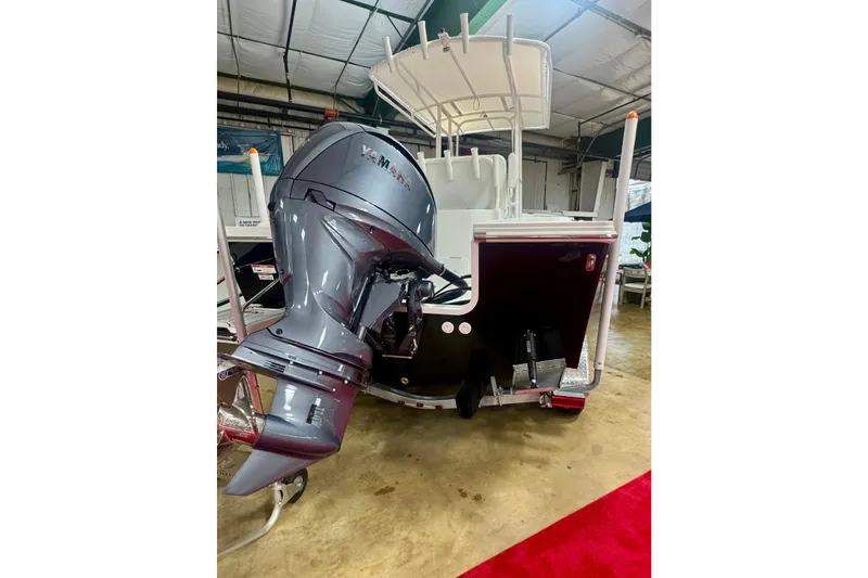 Slide: The Image of 2026 Parker 210 Coastal boat with Yamaha outboard motor in showroom. - 2