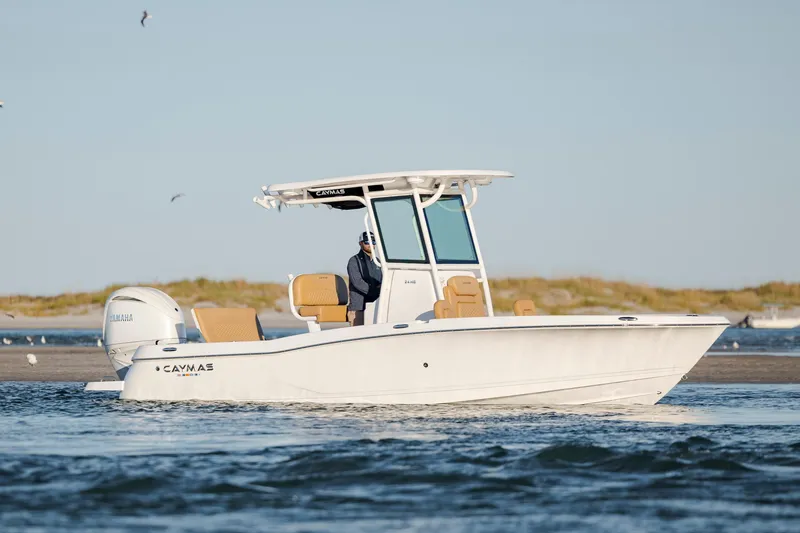 The Image of 2026 Caymas 24 HB boat on water, featuring sleek design and Yamaha engine. - 0