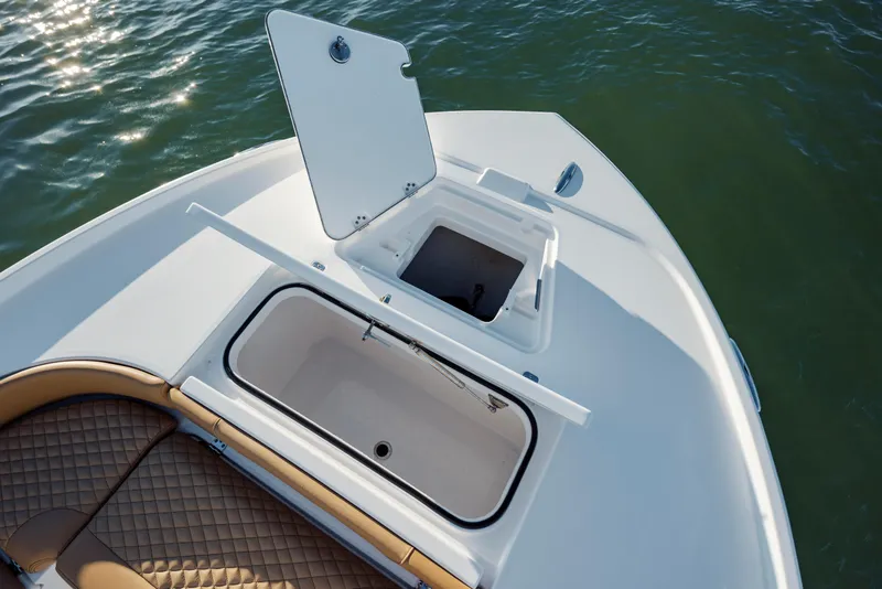Slide: The Image of 2026 Caymas 24 HB boat with open storage compartments on deck. - 11