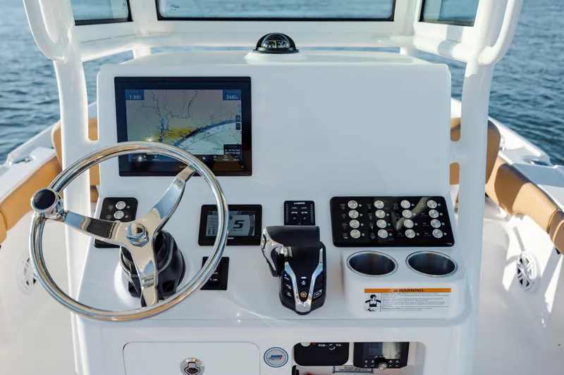 Slide: The Image of 2026 Caymas 24 HB boat console with steering wheel, navigation screen, and controls. - 18