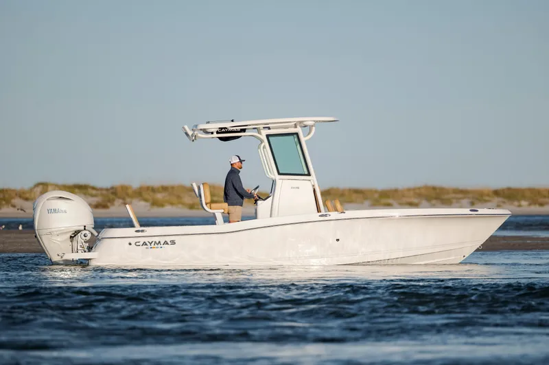 Slide: The Image of 2026 Caymas 24 HB boat cruising on water with Yamaha engine. - 2
