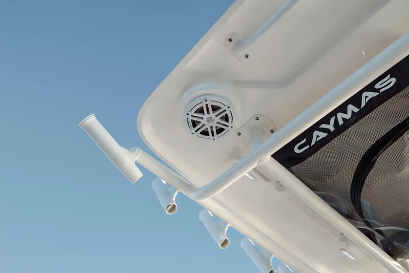 Slide: The Image of 2026 Caymas 24 HB boat detail with rod holders and speaker against clear sky. - 20