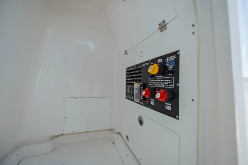 Slide: The Image of 2026 Caymas 24 HB boat electrical panel with switches and controls. - 24