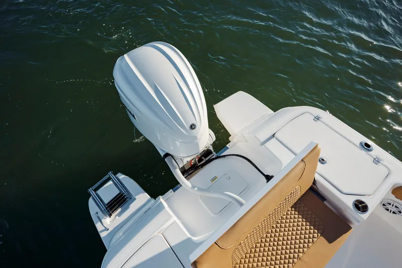 Slide: The Image of 2026 Caymas 24 HB boat with outboard motor on water. - 25