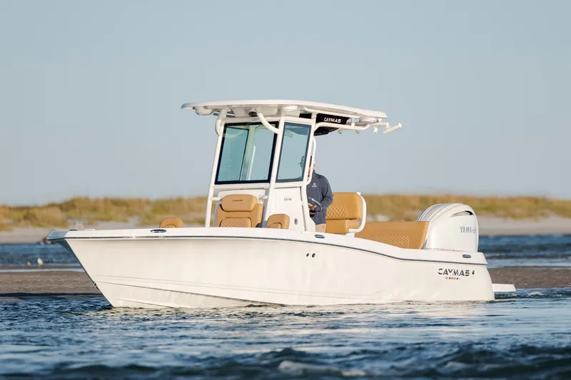 Slide: The Image of 2026 Caymas 24 HB boat cruising on water with scenic background. - 7