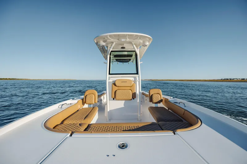 Slide: The Image of 2026 Caymas 24 HB boat on open water, featuring spacious seating and sleek design. - 9