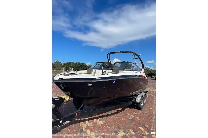 Slide: The Image of 2015 Yamaha Boats 242 Limited S on trailer, under clear blue sky. - 1