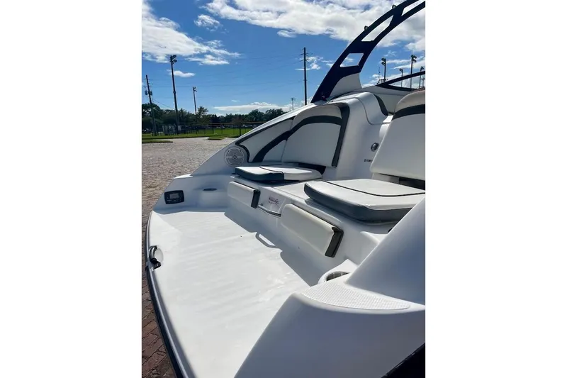 Slide: The Image of 2015 Yamaha Boats 242 Limited S, rear seating area, sunny day, outdoor setting. - 15