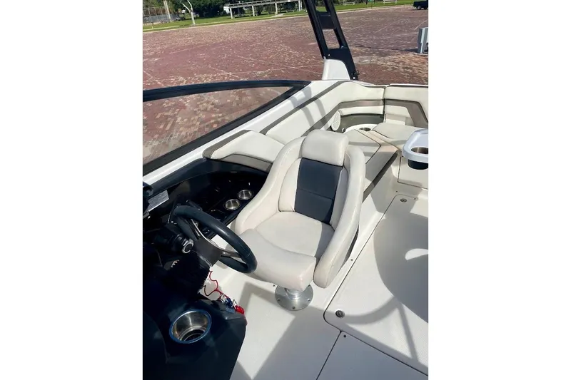Slide: The Image of 2015 Yamaha Boats 242 Limited S interior with steering wheel and seating area. - 9