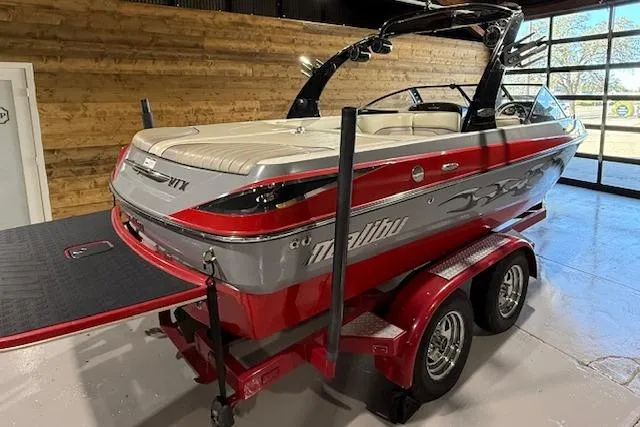 Slide: The Image of 2007 Malibu Wakesetter 20 VTX boat on a red trailer in a showroom. - 3