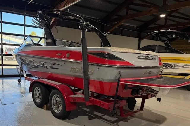 Slide: The Image of 2007 Malibu Wakesetter 20 VTX boat in showroom, red and silver design, on trailer. - 7