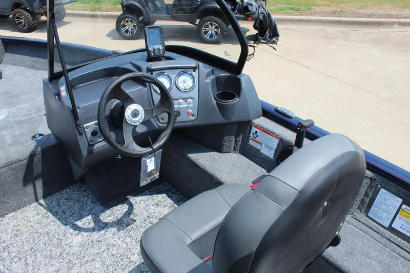 Slide: The Image of 2026 Tracker Pro Guide V-16 WT boat interior with steering wheel and dashboard controls. - 11