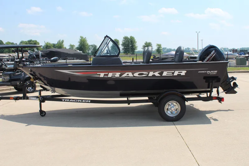 Slide: The Image of 2026 Tracker Pro Guide V-16 WT boat on trailer, side view, outdoors. - 4