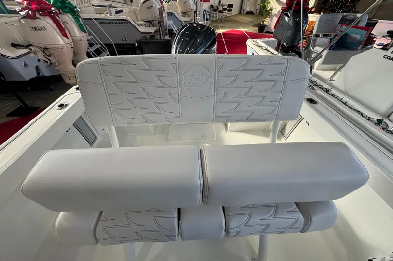 Slide: The Image of 2026 Parker 210 Coastal boat interior with white cushioned seating and detailed stitching. - 8
