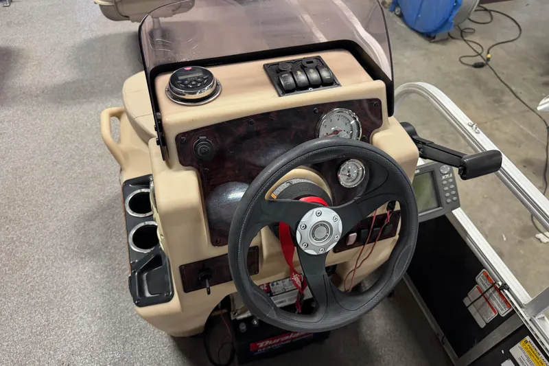 Slide: The Image of 2018 Sun Tracker Bass Buggy 18 DLX dashboard with steering wheel and controls. - 10