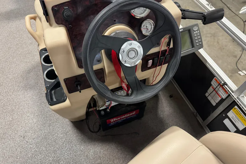Slide: The Image of 2018 Sun Tracker Bass Buggy 18 DLX steering console with gauges and controls. - 11