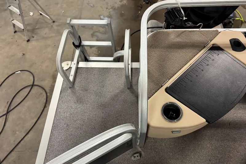 Slide: The Image of 2018 Sun Tracker Bass Buggy 18 DLX boat deck with ladder and control panel. - 14