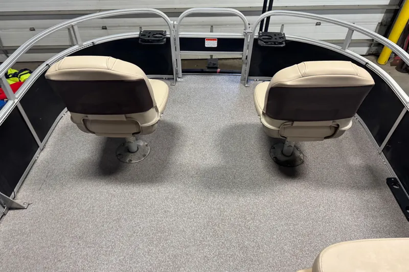 Slide: The Image of 2018 Sun Tracker Bass Buggy 18 DLX pontoon boat interior with two swivel seats. - 19