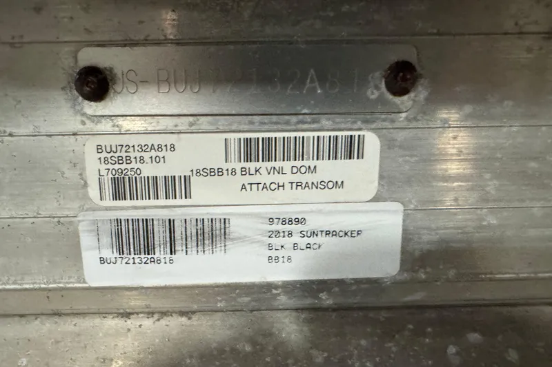 Slide: The Image of 2018 Sun Tracker Bass Buggy 18 DLX identification labels on metal surface. - 4