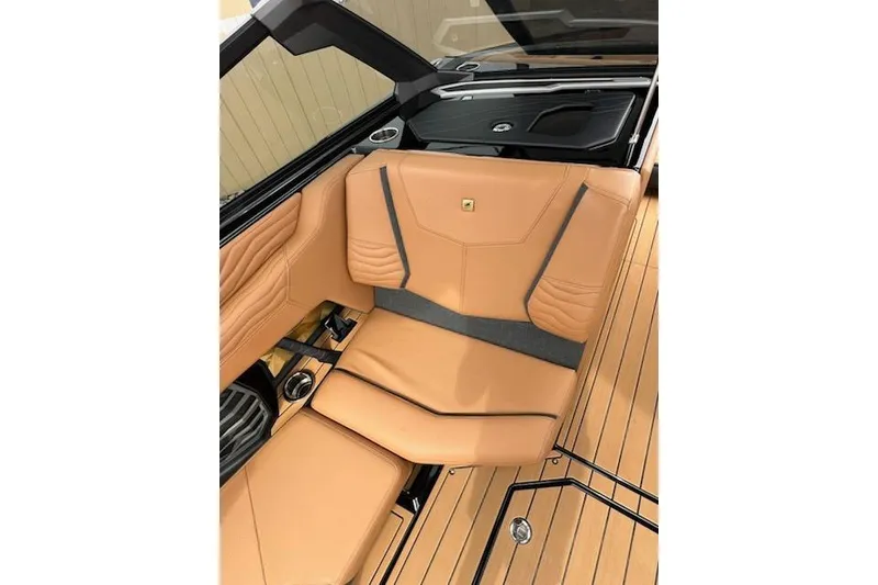 Slide: The Image of 2025 Nautique Super Air Nautique G23 interior with tan leather seating and sleek design. - 10