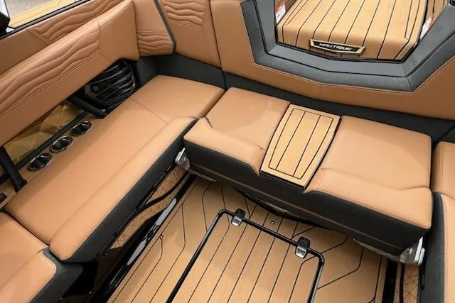 Slide: The Image of Luxurious interior of 2025 Nautique Super Air Nautique G23 boat with tan seating. - 12