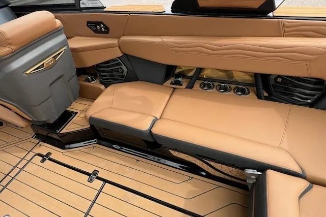 Slide: The Image of Luxurious interior of 2025 Nautique Super Air Nautique G23 with tan leather seating. - 13