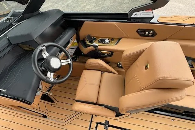 Slide: The Image of 2025 Nautique Super Air Nautique G23 cockpit with luxurious tan seating and modern controls. - 17