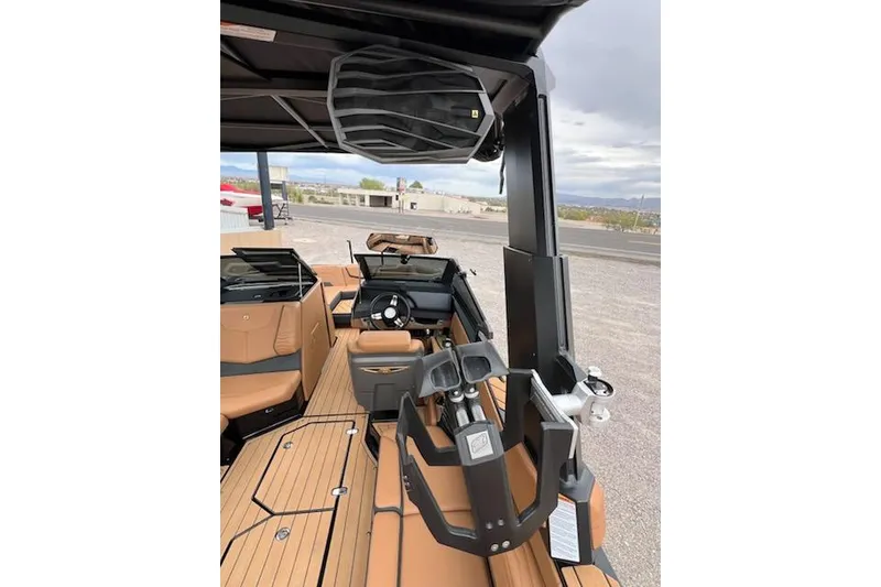 Slide: The Image of 2025 Nautique Super Air Nautique G23 interior with tan seating and modern dashboard. - 18