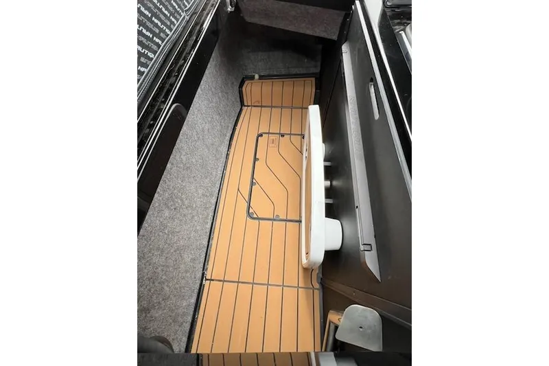 Slide: The Image of 2025 Nautique Super Air Nautique G23 interior with teak flooring and sleek design. - 21
