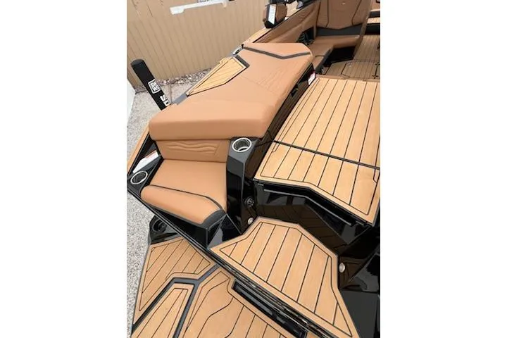 Slide: The Image of 2025 Nautique Super Air Nautique G23 boat interior with tan seating and sleek design. - 24
