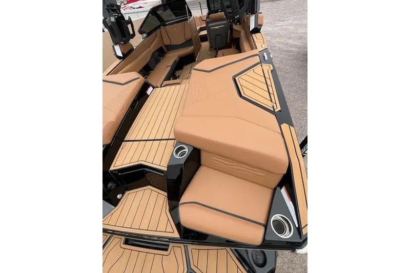 Slide: The Image of 2025 Nautique Super Air Nautique G23 interior with tan seating and sleek design. - 25