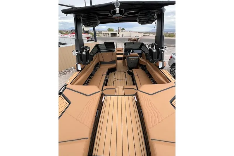 Slide: The Image of 2025 Nautique Super Air Nautique G23 interior with tan seating and modern dashboard. - 26