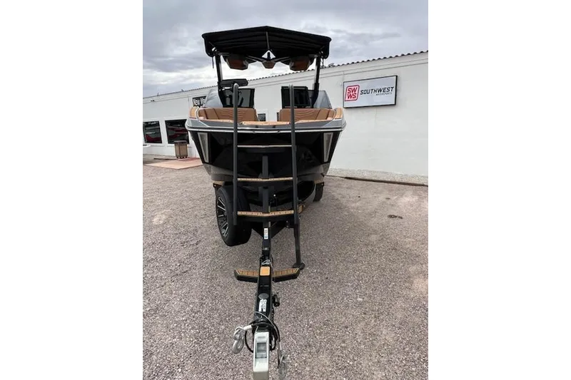 Slide: The Image of 2025 Nautique Super Air Nautique G23 boat on trailer, parked outside dealership. - 3