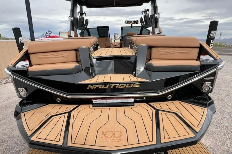 Slide: The Image of 2025 Nautique Super Air Nautique G23 boat, rear view with luxurious seating and teak flooring. - 6