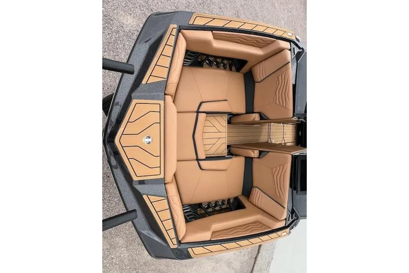 Slide: The Image of 2025 Nautique Super Air Nautique G23 boat interior with tan upholstery and sleek design. - 7