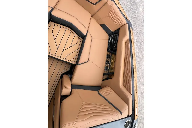 Slide: The Image of Luxurious interior of 2025 Nautique Super Air Nautique G23 boat with tan upholstery. - 9