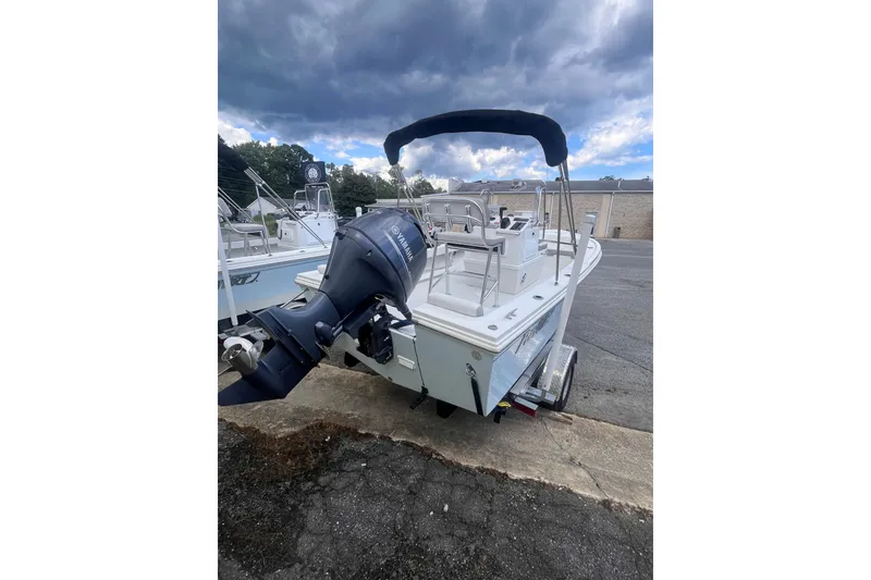 Slide: The Image of 2026 Parker 210 Coastal boat interior with white cushioned seating. - 10